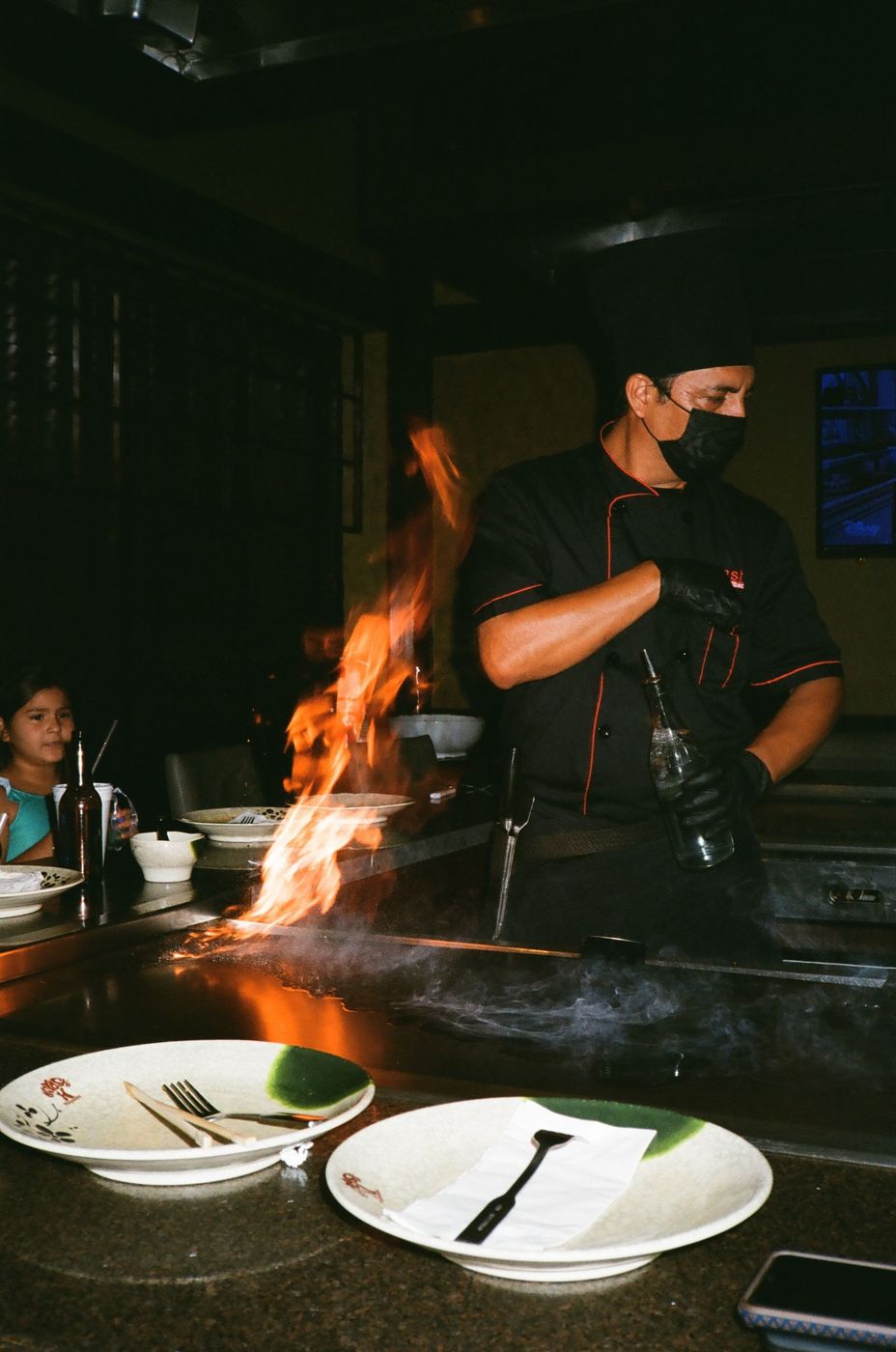 El itamae trabajando con fuego frente a la barra